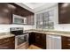 Well-equipped kitchen featuring stainless steel appliances and a window view at 2875 W Highland St # 1213, Chandler, AZ 85224