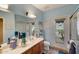 Light and airy bathroom with walk-in shower, wood vanity and outside access at 3134 N 145Th Ave, Goodyear, AZ 85395