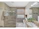Stylish bathroom with a glass-enclosed shower, granite countertop and tiled walls at 3134 N 145Th Ave, Goodyear, AZ 85395