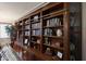 Floor-to-ceiling custom wood bookcase with ladder at 3134 N 145Th Ave, Goodyear, AZ 85395