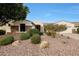 Landscaped front yard featuring stone accents and desert flora creates inviting curb appeal at 3134 N 145Th Ave, Goodyear, AZ 85395