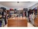 Spacious walk-in closet with custom shelving, drawers and ample storage space at 3134 N 145Th Ave, Goodyear, AZ 85395