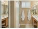Bright bathroom with double sinks, a shower, and shuttered windows at 3362 N 159Th Ave, Goodyear, AZ 85395