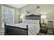 Cozy bedroom features a black bed frame, nightstands with lamps, and shuttered windows at 3362 N 159Th Ave, Goodyear, AZ 85395