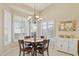 Cozy dining area featuring a chandelier and bright windows with plantation shutters at 3362 N 159Th Ave, Goodyear, AZ 85395