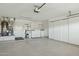 Spacious garage with laundry hookups, lots of storage cabinets and white painted floors at 3362 N 159Th Ave, Goodyear, AZ 85395