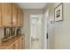 Hallway with cabinets and countertops leading to a bathroom, with tiled floors at 3362 N 159Th Ave, Goodyear, AZ 85395