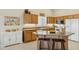 Bright kitchen with wood cabinets, tile floors, and a spacious breakfast bar at 3362 N 159Th Ave, Goodyear, AZ 85395