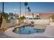 Sparkling backyard pool with a spa, surrounded by palm trees and a privacy wall at 3362 N 159Th Ave, Goodyear, AZ 85395