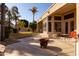 Covered back patio featuring a small table and chair set next to a gas firepit at 3631 S Greythorne S Way, Chandler, AZ 85248
