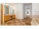 Bathroom with dual sinks, tile flooring, and a soaking tub adjacent to the vanity at 3631 S Greythorne S Way, Chandler, AZ 85248