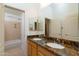 Bathroom featuring double sinks, granite countertops, and a bathtub with shower at 3631 S Greythorne S Way, Chandler, AZ 85248