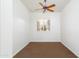 Neutral bedroom with a window, a ceiling fan, and neutral carpeting at 3631 S Greythorne S Way, Chandler, AZ 85248