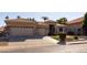 Tan single-story home with a three car garage and stone accents on the facade at 3631 S Greythorne S Way, Chandler, AZ 85248