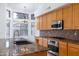 Bright kitchen features granite countertops, stainless steel appliances and a large window with neighborhood views at 3631 S Greythorne S Way, Chandler, AZ 85248