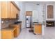 Open kitchen with stainless steel appliances, granite countertops, and a view of the fireplace, great for entertaining at 3631 S Greythorne S Way, Chandler, AZ 85248