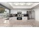 Modern kitchen with stainless steel appliances, granite countertops, and white cabinetry at 3743 W Hartford Ave, Glendale, AZ 85308