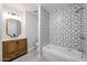 Stylish bathroom featuring patterned wall tiles, a wood vanity, and modern fixtures at 38234 N 15Th Ave, Phoenix, AZ 85086