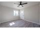 Bright bedroom with wood-look tile flooring, a modern ceiling fan, and natural light at 38234 N 15Th Ave, Phoenix, AZ 85086