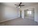 Carpeted bedroom with a mirrored closet door and a ceiling fan for comfort at 38234 N 15Th Ave, Phoenix, AZ 85086