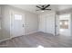 Bedroom with sleek plank flooring, a modern ceiling fan, and access to another room at 38234 N 15Th Ave, Phoenix, AZ 85086