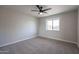 Cozy carpeted bedroom featuring a modern ceiling fan and a bright window at 38234 N 15Th Ave, Phoenix, AZ 85086