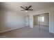 Bedroom with carpet, ceiling fan, and mirrored closet; offering a bright, open feel at 38234 N 15Th Ave, Phoenix, AZ 85086