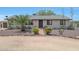 Charming single-story home with desert landscaping, mature palm tree, and quaint red brick walkway leading to the front door at 38234 N 15Th Ave, Phoenix, AZ 85086