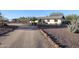 Single-level home with desert landscaping, a circular drive, and privacy wall at 38234 N 15Th Ave, Phoenix, AZ 85086