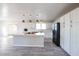 Bright, open kitchen features white cabinets, stainless steel appliances, a large island with quartz countertops, and stylish pendant lights at 38234 N 15Th Ave, Phoenix, AZ 85086