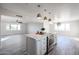 Open kitchen with a large island, stainless steel appliances, and seamless transition to a spacious living room with lots of light at 38234 N 15Th Ave, Phoenix, AZ 85086