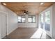 Bright living room with wood plank ceiling, ceiling fan, tiled floors and double glass doors at 38234 N 15Th Ave, Phoenix, AZ 85086