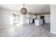 Open concept kitchen and living room with tile floors, white cabinetry, stainless steel appliances and an island with quartz countertops at 38234 N 15Th Ave, Phoenix, AZ 85086