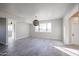 Open living room featuring tiled floors, neutral walls, and a decorative hanging pendant light at 38234 N 15Th Ave, Phoenix, AZ 85086