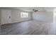 Bright living room with wood-look tiled floors, a ceiling fan, and ample natural light at 38234 N 15Th Ave, Phoenix, AZ 85086