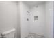 Modern bathroom featuring a walk-in shower with pebble flooring and tiled walls at 38234 N 15Th Ave, Phoenix, AZ 85086