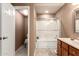 Cozy bathroom featuring a shower with glass doors, a vanity with a sink and tile floors at 4122 E Jojoba Rd, Phoenix, AZ 85044