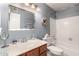 Clean bathroom with a single sink vanity, a toilet, and a shower featuring a seashell wreath decor at 4122 E Jojoba Rd, Phoenix, AZ 85044