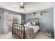 Comfortable bedroom with decor shelves and a ceiling fan above the bed, providing air circulation at 4122 E Jojoba Rd, Phoenix, AZ 85044