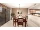 Cozy dining room with a wooden table set for six, and a sliding glass door at 4122 E Jojoba Rd, Phoenix, AZ 85044