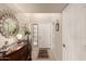 Inviting entryway with tile flooring, a wood dresser, and a decorative mirror and light at 4122 E Jojoba Rd, Phoenix, AZ 85044