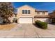 Two-story home featuring a three-car garage, tile roof, and a tidy yard with mature landscaping at 4122 E Jojoba Rd, Phoenix, AZ 85044