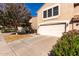 Two-story home featuring a two-car garage, tile roof, and a tidy yard with mature landscaping at 4122 E Jojoba Rd, Phoenix, AZ 85044