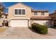 Two-story home featuring a three-car garage, tile roof, and a tidy yard with mature landscaping at 4122 E Jojoba Rd, Phoenix, AZ 85044