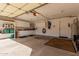 Spacious garage with ample storage, white cabinetry, and an automatic door, perfect for organization at 4122 E Jojoba Rd, Phoenix, AZ 85044