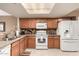 Well-lit kitchen with matching appliances and an eat-in counter at 4122 E Jojoba Rd, Phoenix, AZ 85044