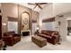 Comfortable living room featuring high ceilings, a fireplace, and plush leather furniture at 4122 E Jojoba Rd, Phoenix, AZ 85044