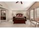 The main bedroom is serene with soft lighting and a view to the ensuite bathroom at 4122 E Jojoba Rd, Phoenix, AZ 85044