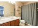 Bright bathroom featuring double sink vanity, neutral walls, geometric curtain and floating shelves for an organized and stylish space at 4258 S Hassett --, Mesa, AZ 85212