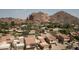 Aerial view of a community showcasing well-maintained homes and stunning mountain backdrops at 4442 E Camelback Rd # 161, Phoenix, AZ 85018